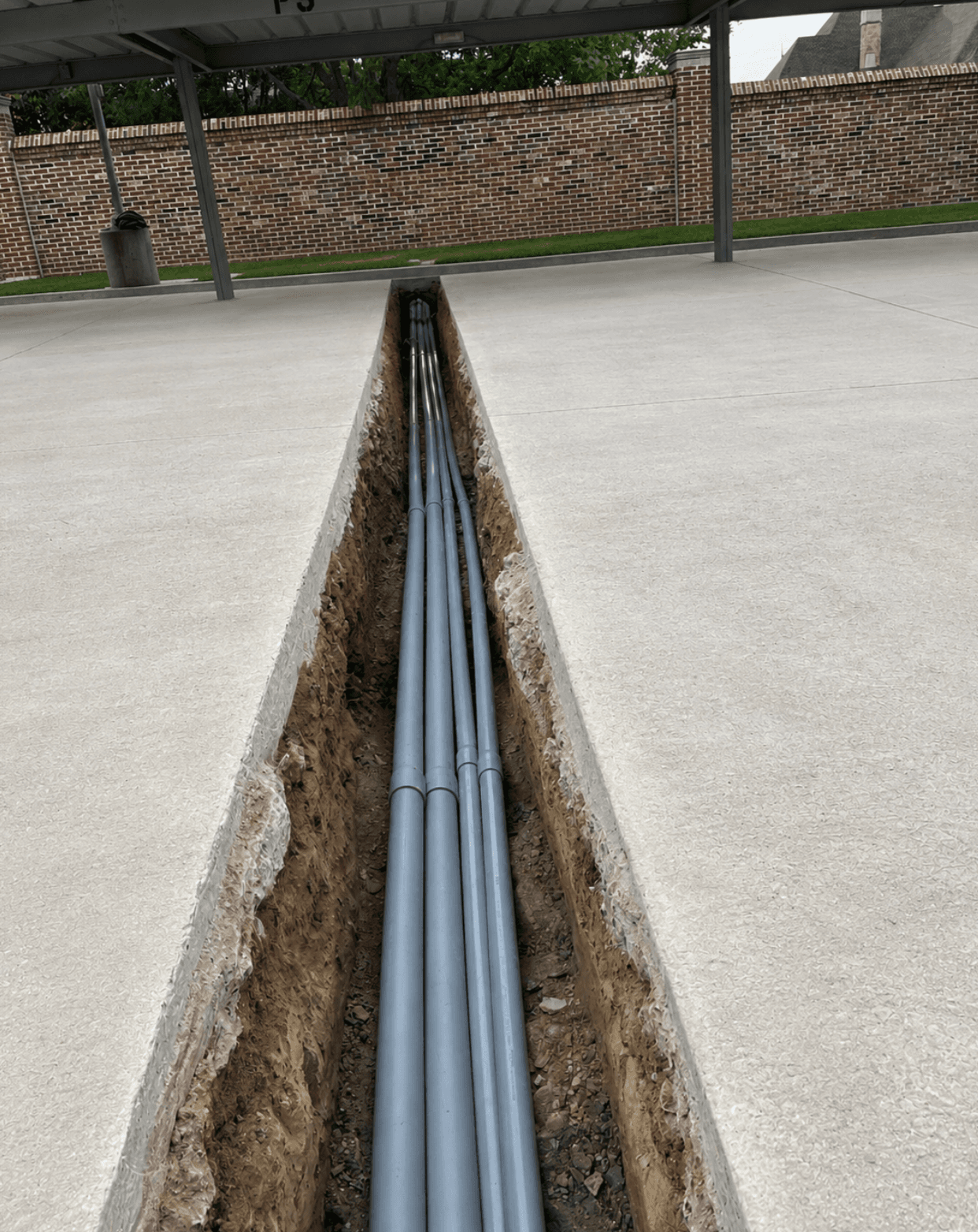 Conduit run laid in an open trench on a DFW jobsite